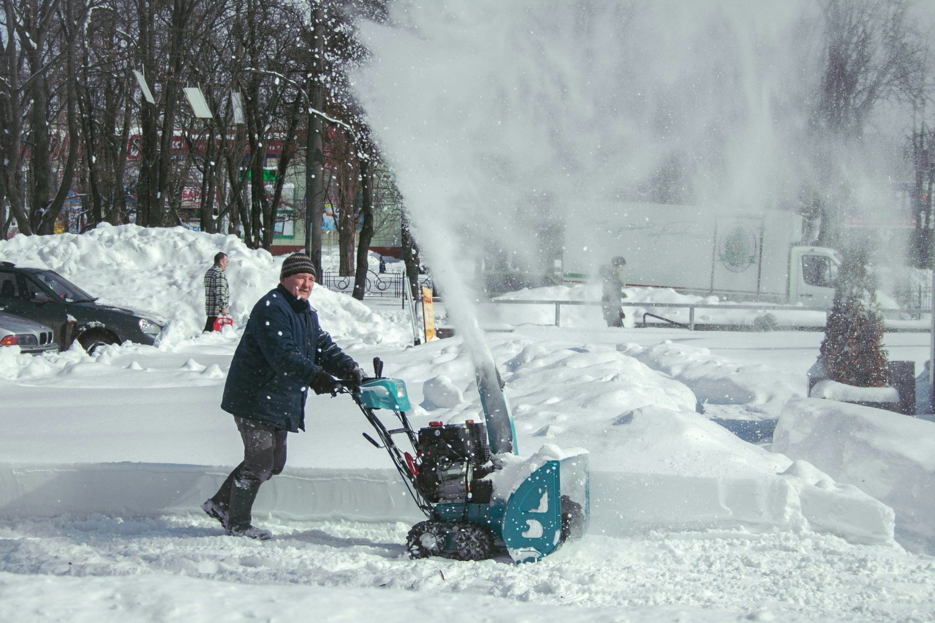 Man operating snow blower during snowfall